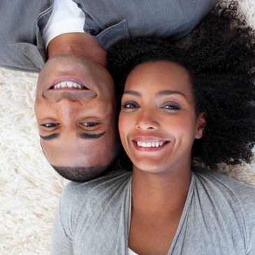 man-woman-laying-smiling