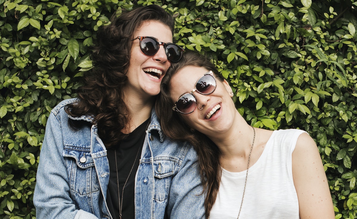 woman-leaning-head-on-another-woman