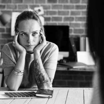 woman-at-work-desk-looking-worried-guesthouse