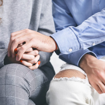 close up of couple holding hands