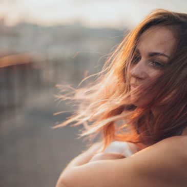 happy woman with the wind blowing against her hair