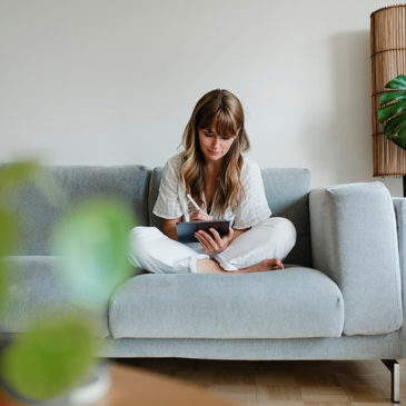 Woman in pyjamas working at home during coronavirus outbreak