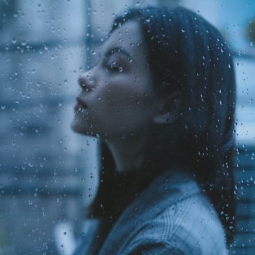 unhappy thoughtful teen girl arms crossed in rainy day