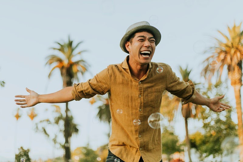 Man holding arms out and smiling