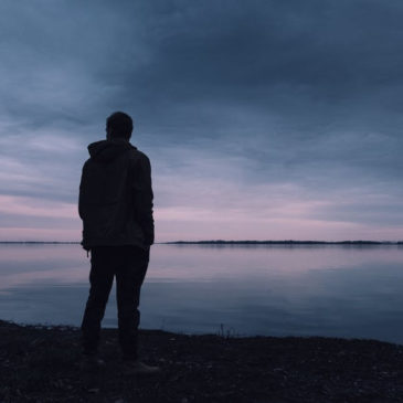 silhouette of a man against a dark sunset