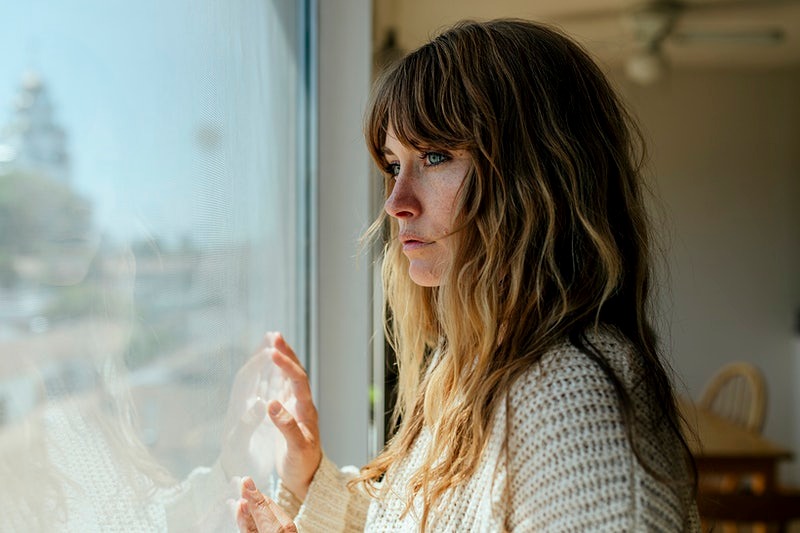 Woman looking out of window